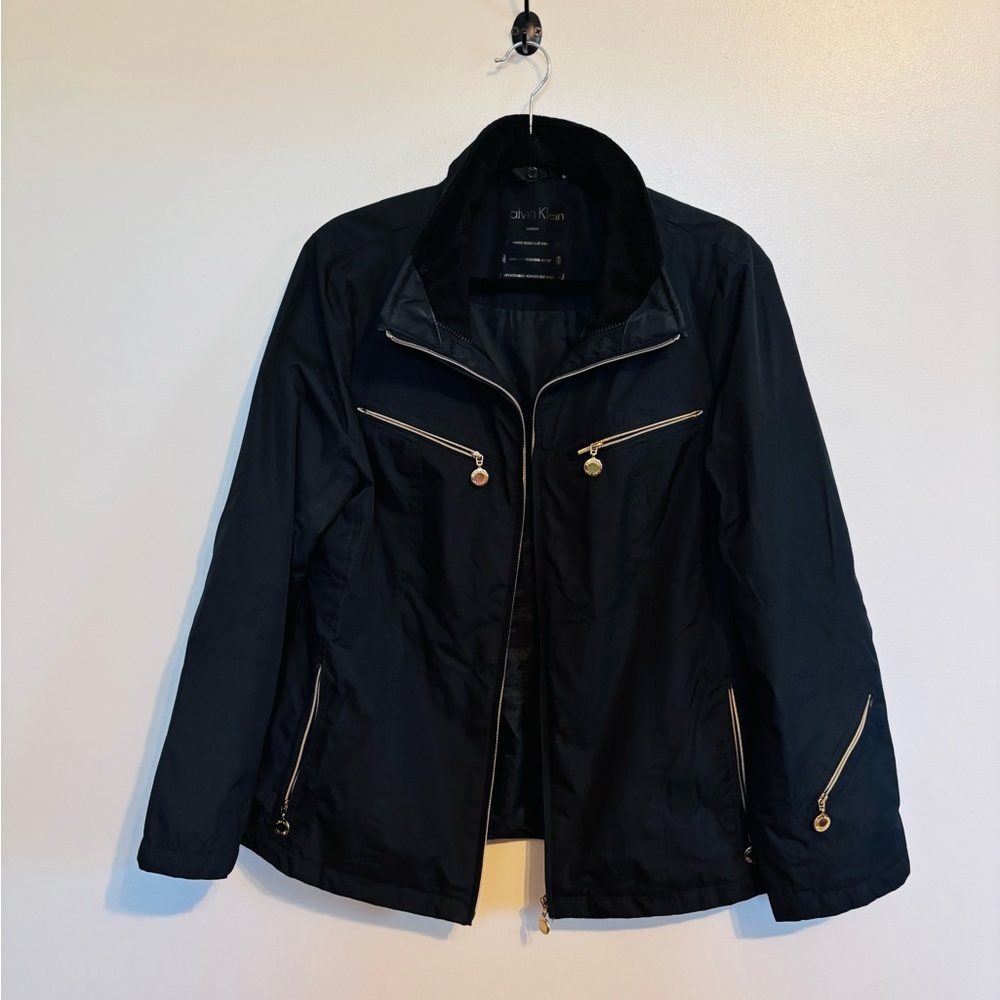 Calvin Klein black rain coat with gold hardware, zip up front size medium.